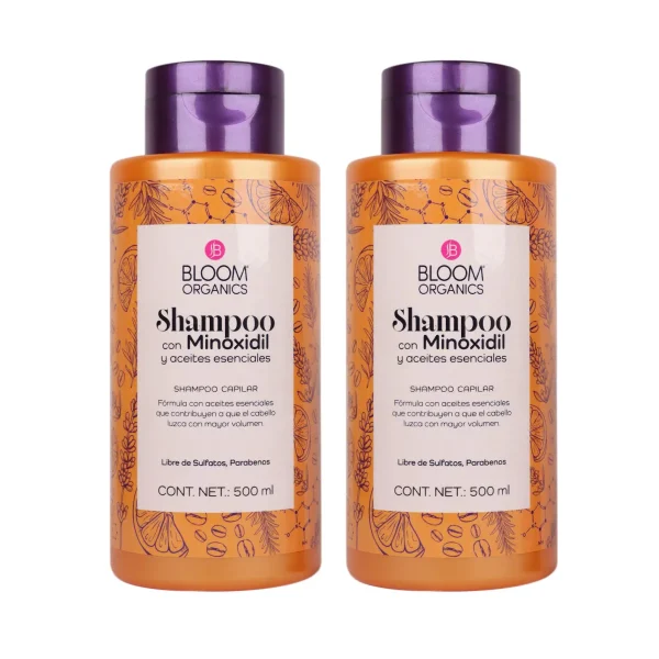 Dos botellas de shampoo Bloom Organics con minoxidil, aceites esenciales y cafeína.